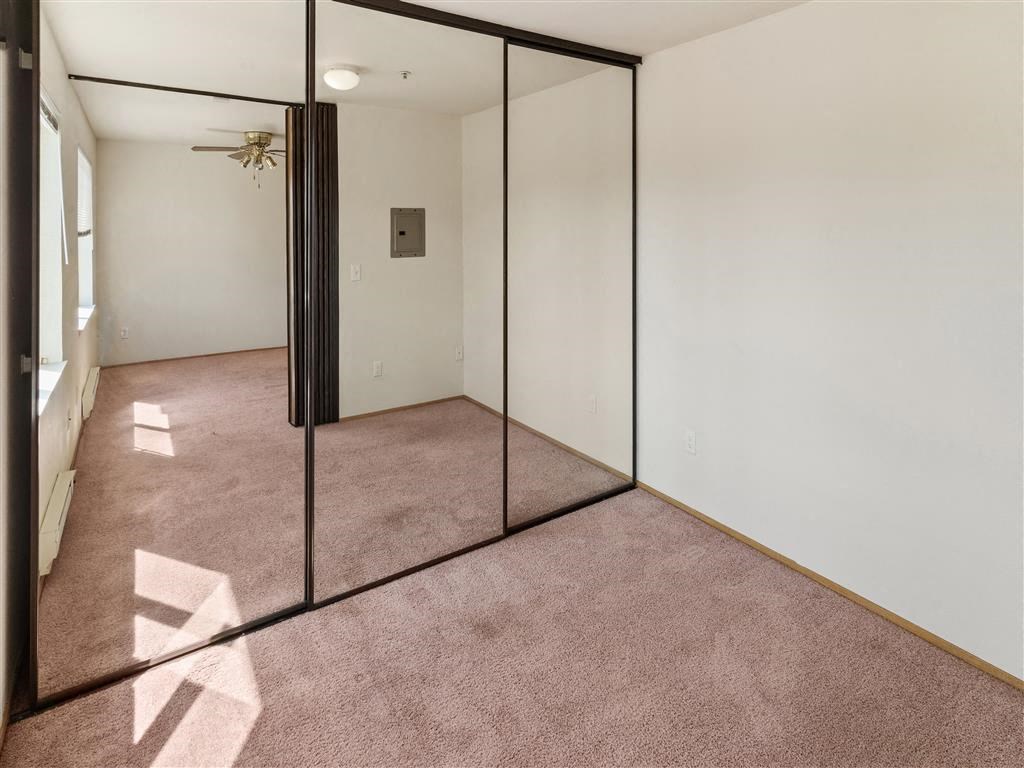 a room with a glass door and carpeted floor at Webster Court Senior Apartments, Washington, 98032