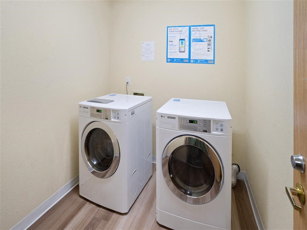 a washer and dryer in a laundry room at Webster Court Senior Apartments, Kent, WA