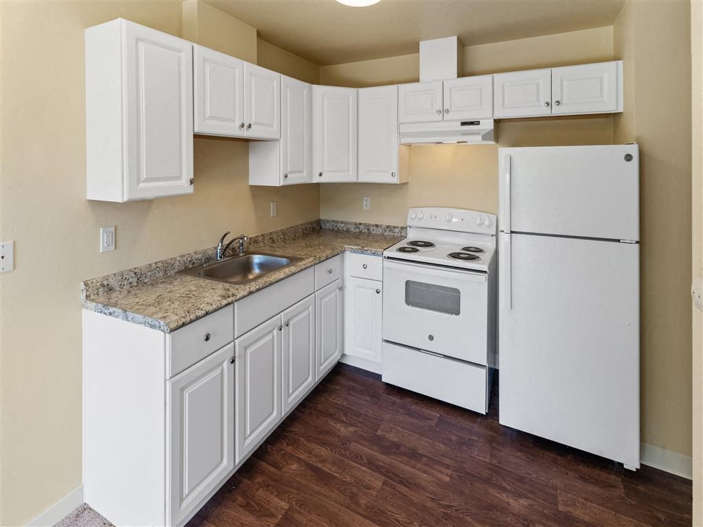 a kitchen with white appliances and white cabinets at Webster Court Senior Apartments, Kent, 98032