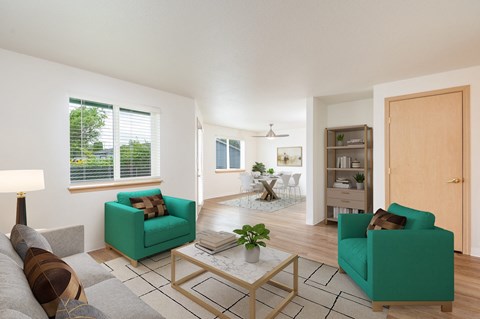 A living room with a green couch, a coffee table, and a lamp.at Vancouver Mall Apartments, Vancouver, WA