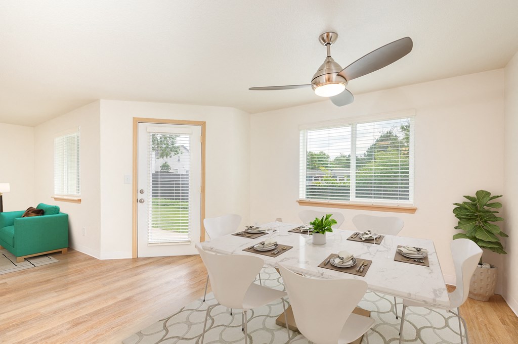 A dining room with a table set for six and a ceiling fan. A dining room with a table set for six and a ceiling fan.at Vancouver Mall Apartments, Vancouver Washington