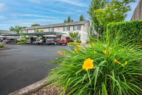 A parking lot with cars and a building in the background.at Vancouver Mall Apartments, Washington