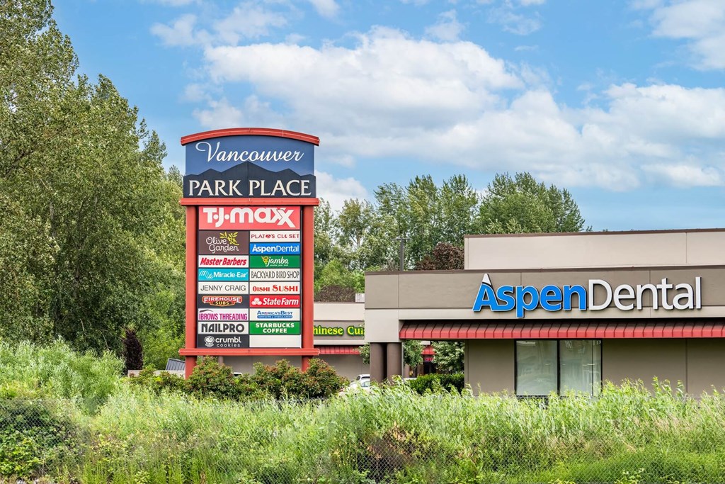 A sign for Vancouver Park Place with a T-Mobile store and an Aspen Dental office.at Vancouver Mall Apartments, Vancouver, WA ? 