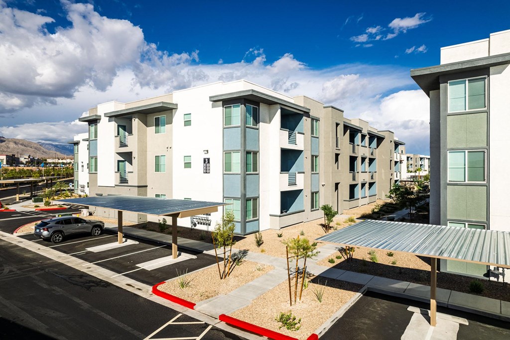 a new apartment building with a parking lot and a blue sky at BASE APARTMENT HOMES, LAS VEGAS, 89166