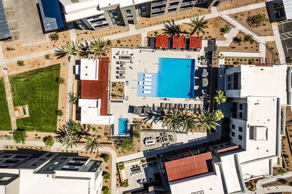 a birds eye view of a building with a blue pool at BASE APARTMENT HOMES, LAS VEGAS, NV 89166