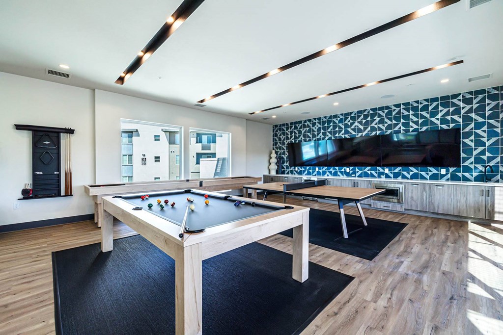 a game room with a pool table and a tv