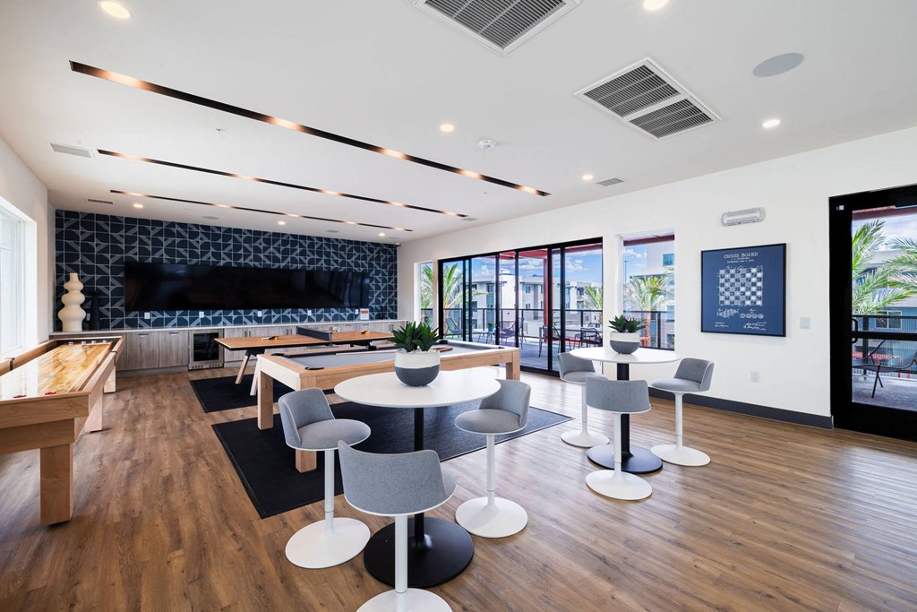 a dining room with tables and chairs and a large window at BASE APARTMENT HOMES, LAS VEGAS, NV 89166