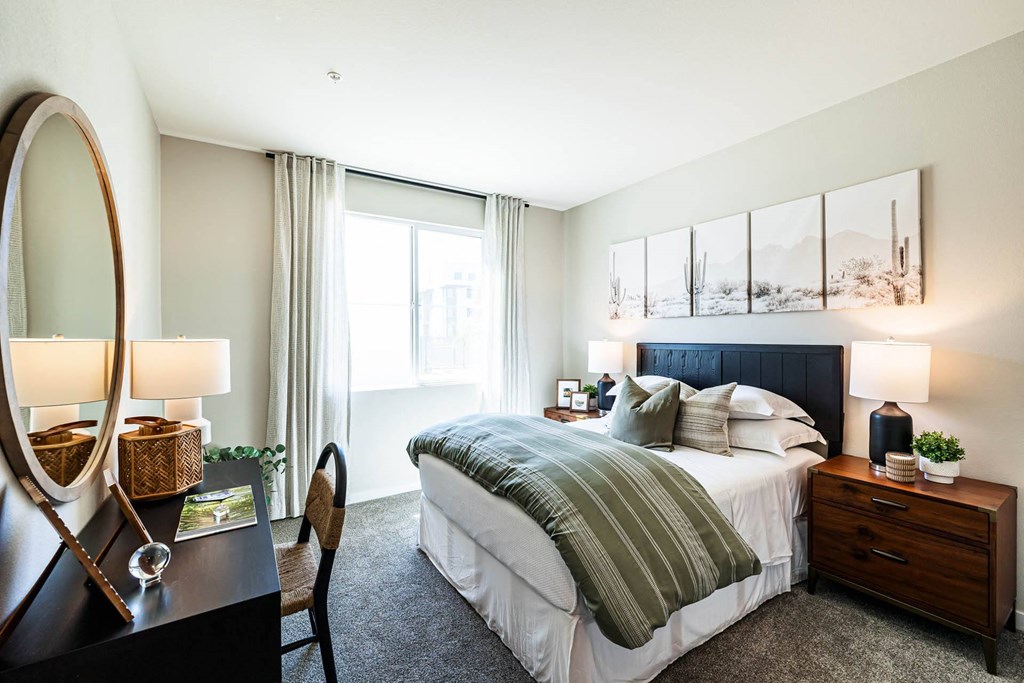 a bedroom with a bed and a desk with a mirror at BASE APARTMENT HOMES, LAS VEGAS, 89166