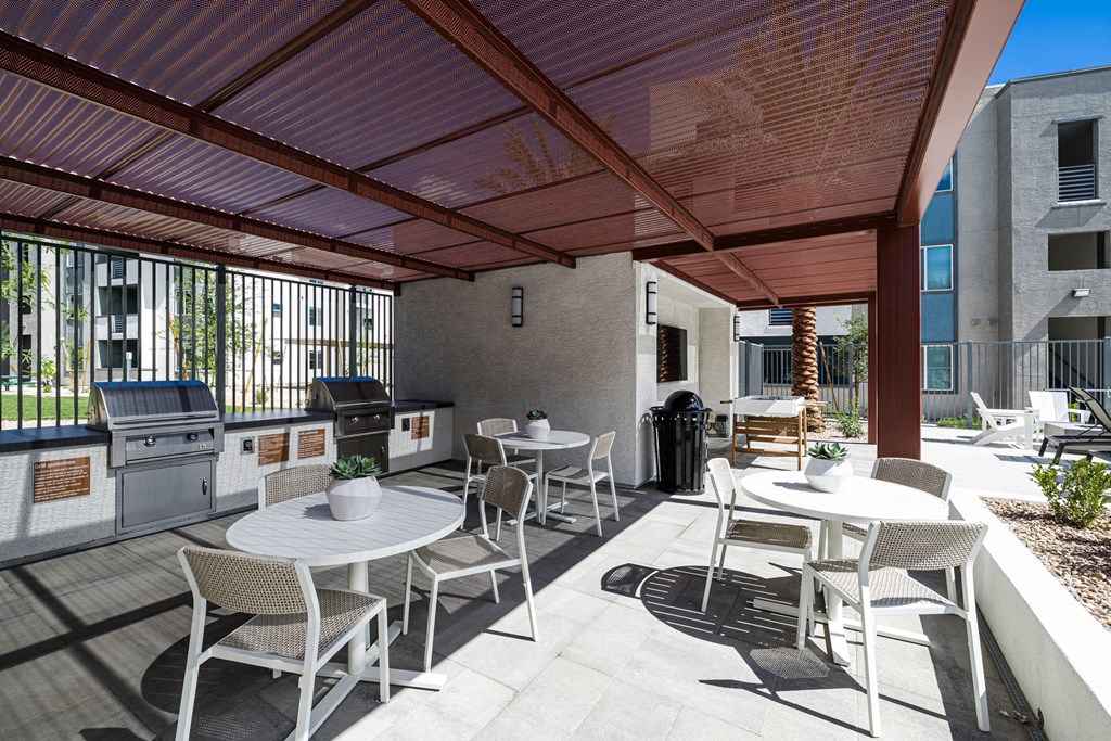 a patio with tables and chairs and a grill at BASE APARTMENT HOMES, LAS VEGAS, Nevada