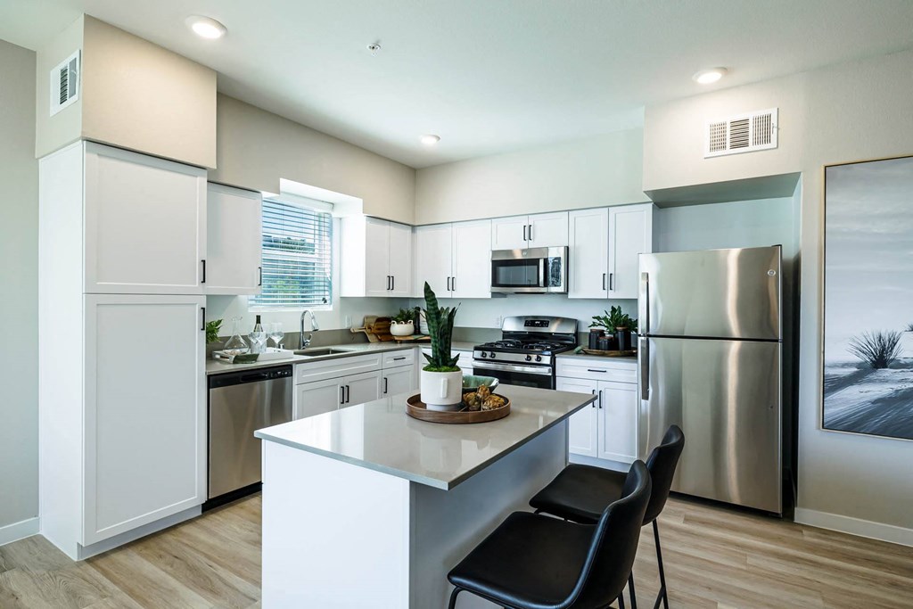 a kitchen with stainless steel appliances and white cabinets at BASE APARTMENT HOMES, LAS VEGAS, NV 89166