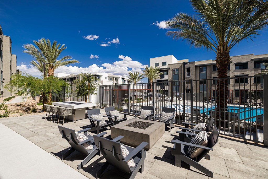a patio with tables and chairs and a swimming pool at BASE APARTMENT HOMES, LAS VEGAS