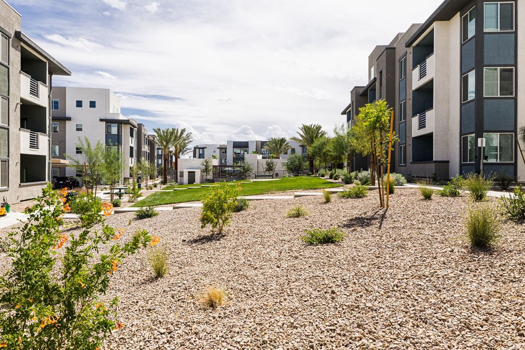 a view of a courtyard between two apartment buildings at BASE APARTMENT HOMES, LAS VEGAS