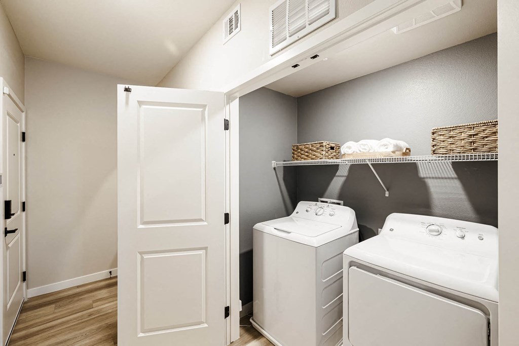 a white washer and dryer in a laundry room with a closet at BASE APARTMENT HOMES, LAS VEGAS, Nevada