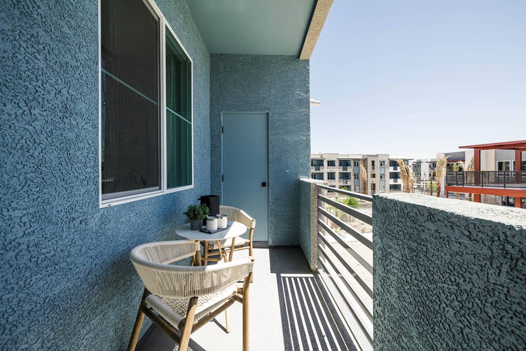 a balcony or terrace with a table and chairs at BASE APARTMENT HOMES, LAS VEGAS, NV