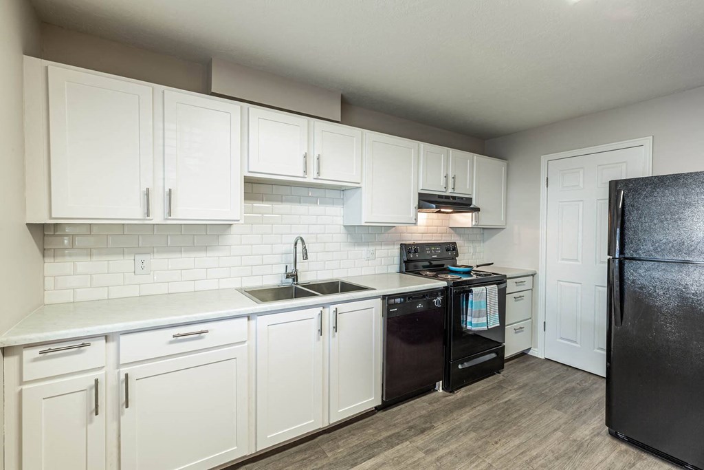 a kitchen with white cabinets and black appliances a kitchen with white cabinets and black appliances at Mountain Run Apartments, Orem, Utah