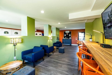 a room with a bar and chairs and a table at Mountain Run Apartments, UT, 84058