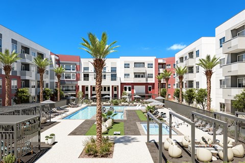 A pool surrounded by palm trees and lounge chairs.