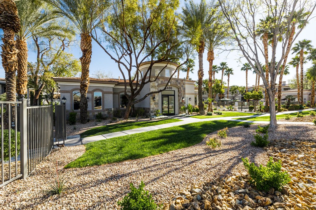 A house with a white fence and a green lawn.