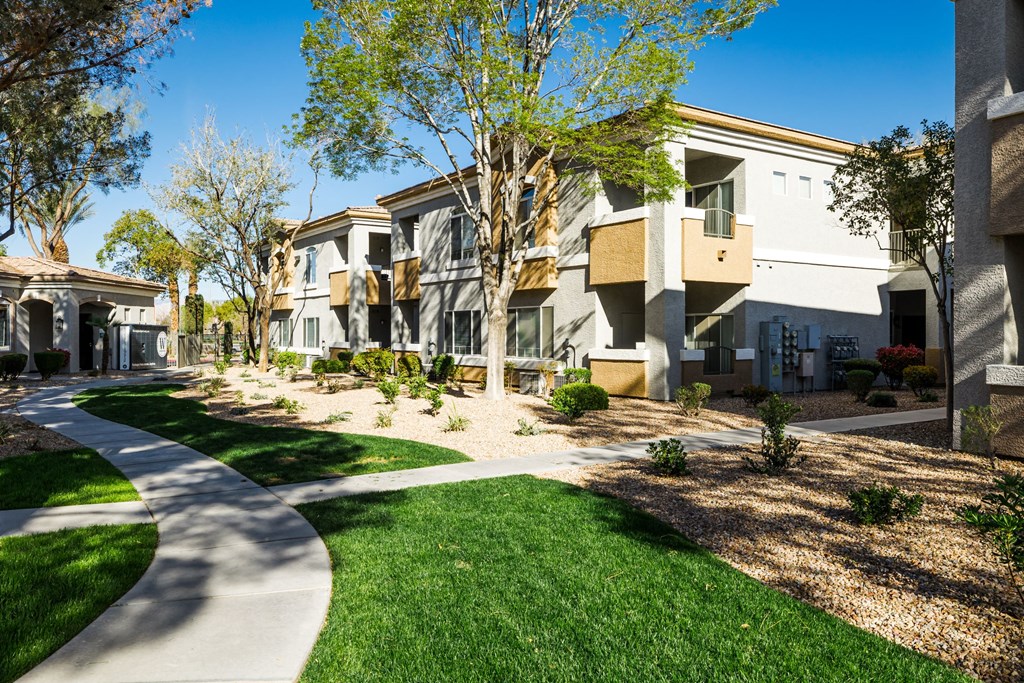 A row of modern houses with a pathway in the foreground.