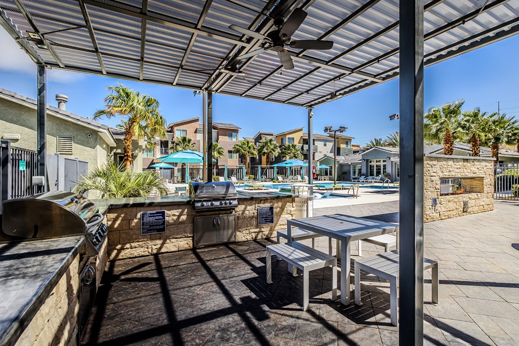 A sunny day at the outdoor grill area with tables and chairs.