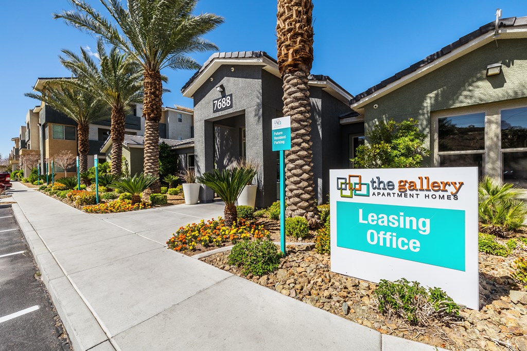A leasing office sign is displayed in front of a building.