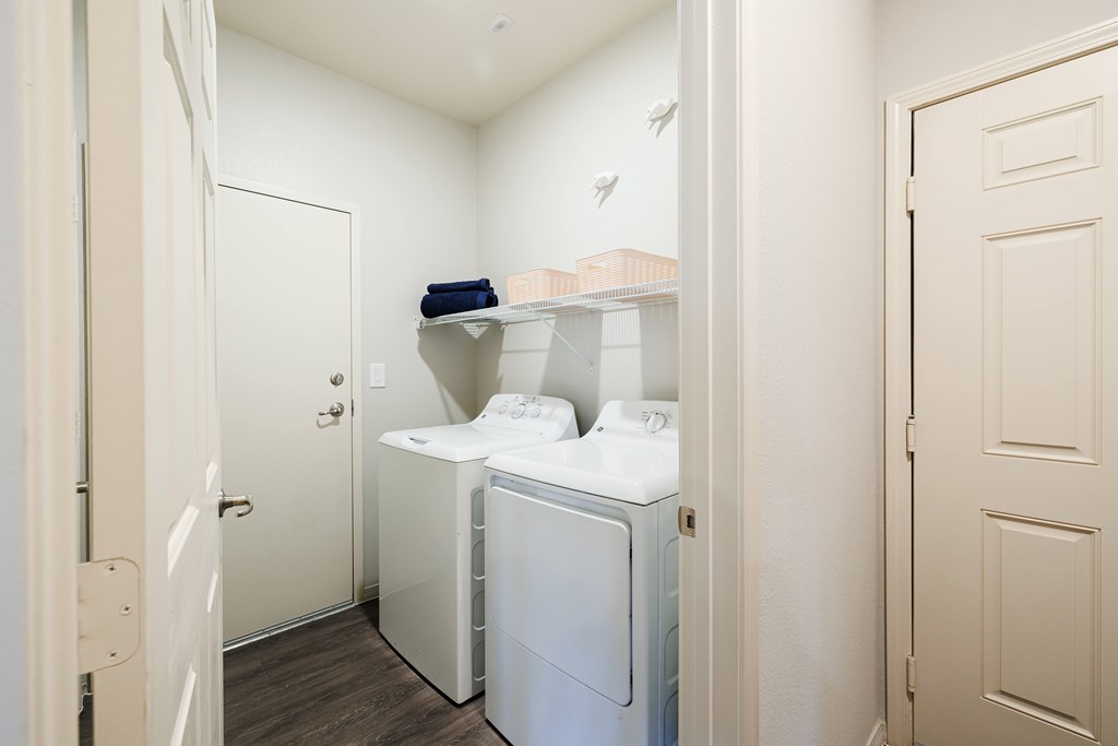 A small laundry room with a washer and dryer.