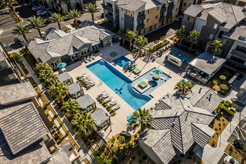 A bird's eye view of a residential area with a swimming pool.