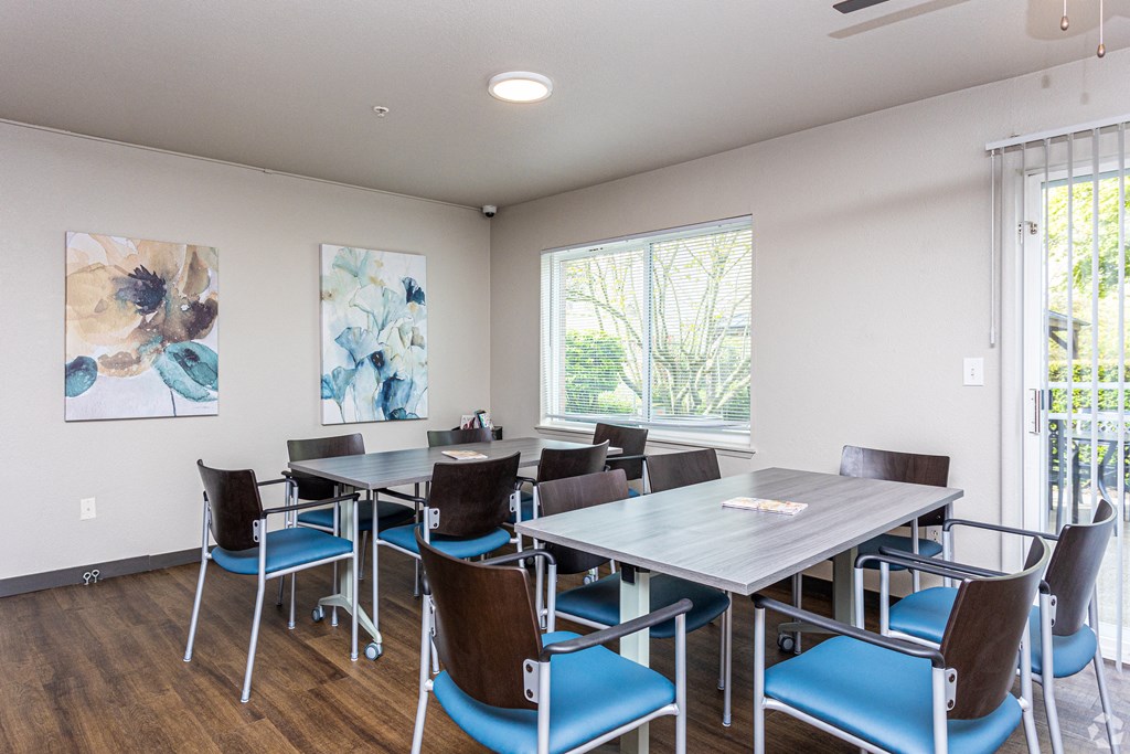 a dining room with tables and chairs and a window