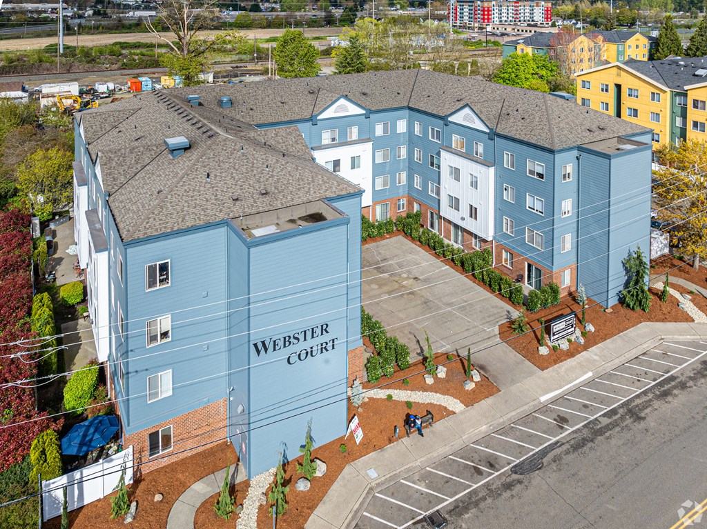 a rendering of a blue building with a sign that reads mercy court
