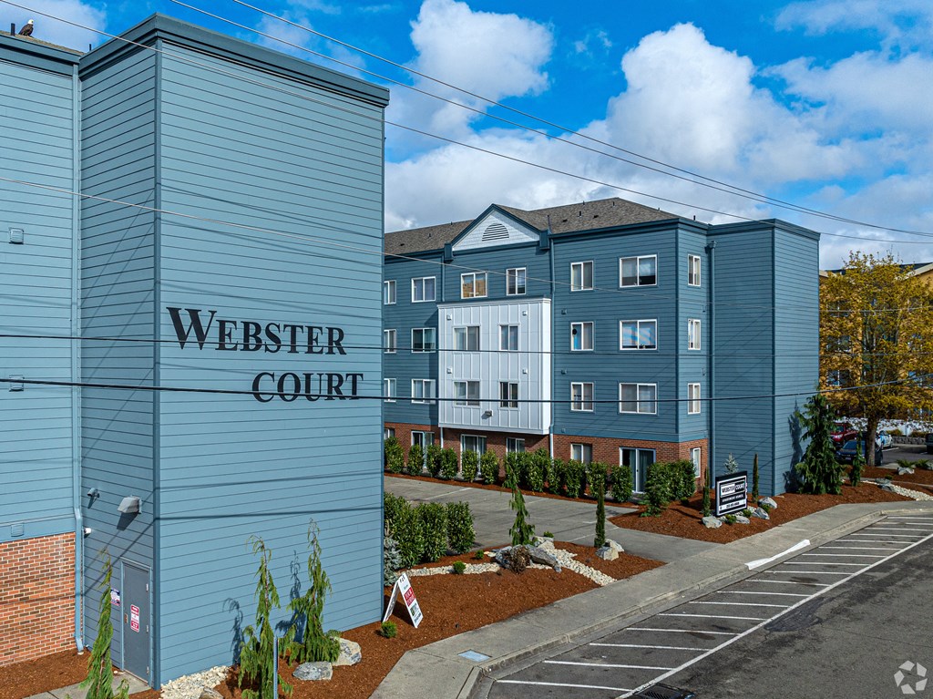 a blue building with a sign that reads webster court