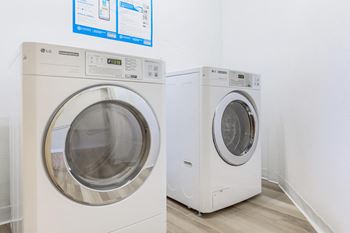 a washer and dryer in a laundry room at Webster Court Senior Apartments, Kent, WA