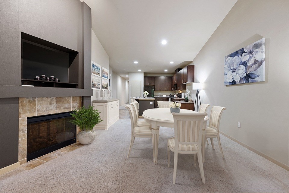 Olympia Apartments for Rent- Yauger Park Vilas- White Dining Room Table and Chairs, Fireplace, and a Flower Wall Painting