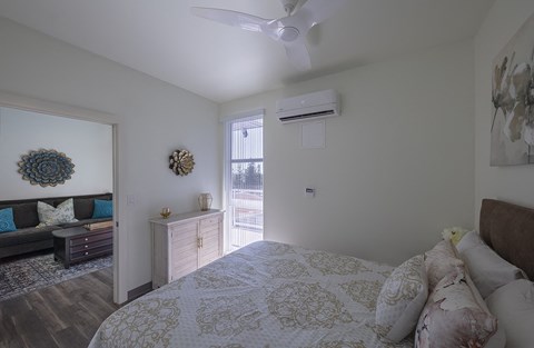 a bedroom with a bed and a ceiling fan