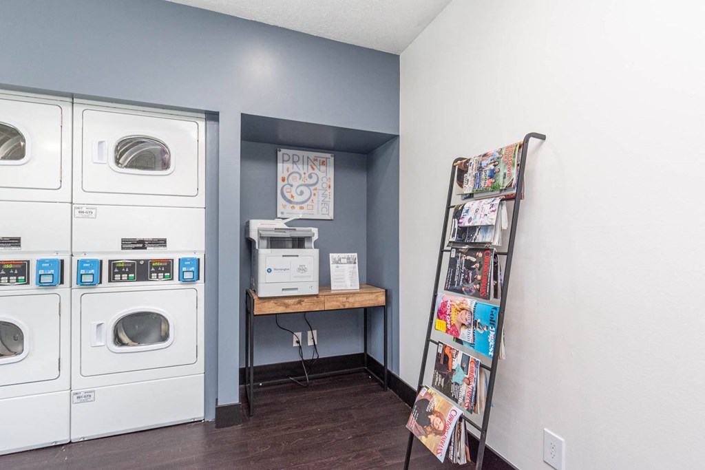a laundry room with washer and dryer and a ladder at Cadence Apartments, Roy, UT