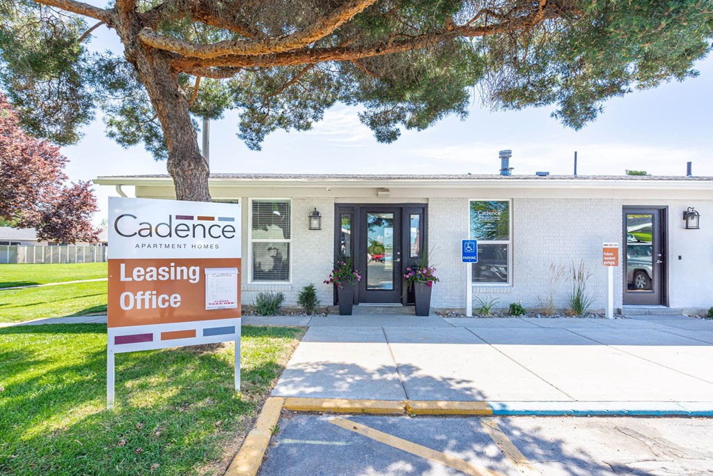a building with a leasing office and a sign in front of it at Cadence Apartments, Roy, 84103