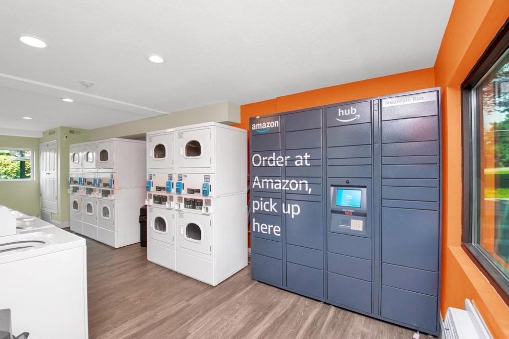 a laundry room with washer and dryer machines and a counter with laundry machines at Mountain Run Apartments, Orem, 84058