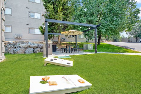 a backyard with a picnic area and a table with food on it at Mountain Run Apartments, Orem, Utah, 84058