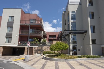Exterior building view with entry to building balconies - Photo Gallery 3