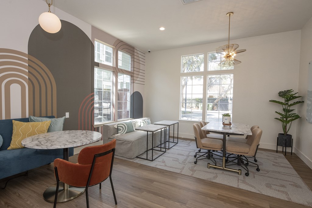 a living room with a table and chairs and a couch