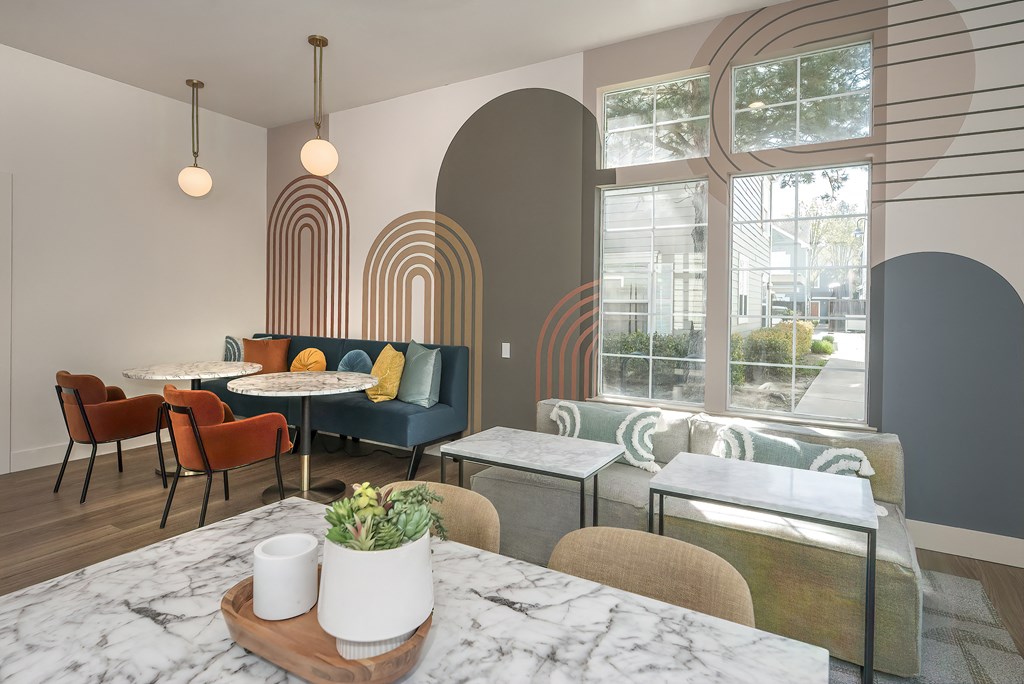 a living room with tables and chairs and a large window