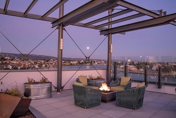 Rooftop seating with firepit l Orion Apartments in Oakland - Photo Gallery 4