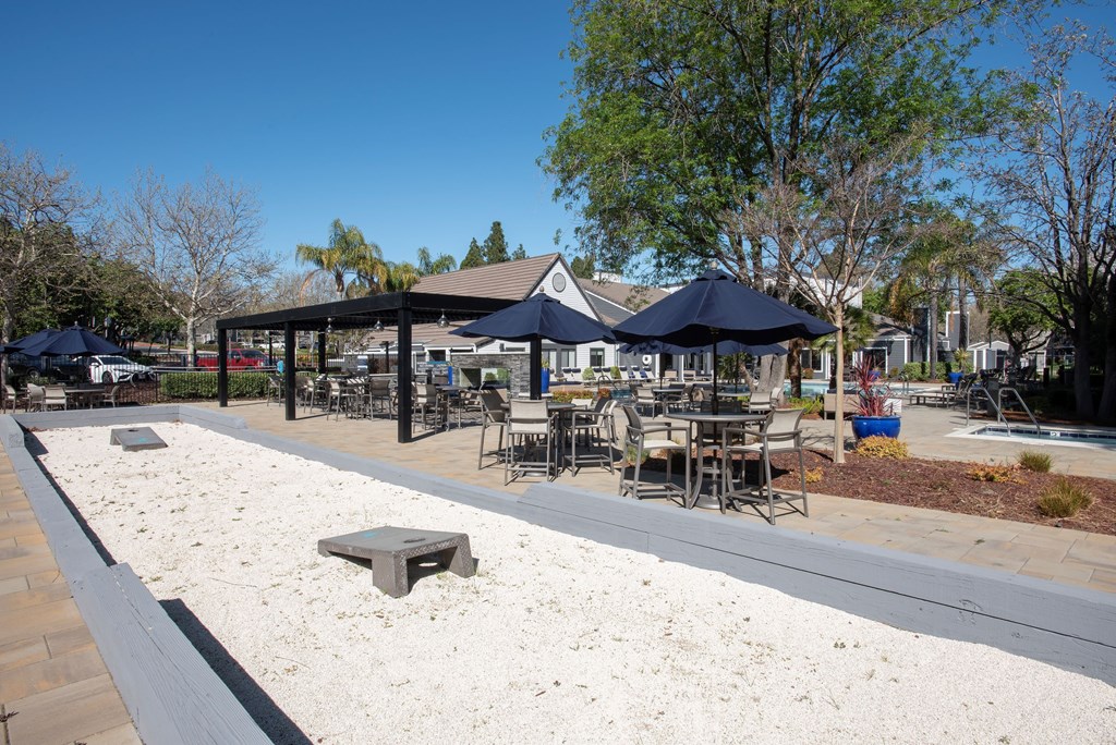 A sandy area with a pavement and a few chairs and tables at Kirker Creek Apartments, Pittsburg, CA, 94565