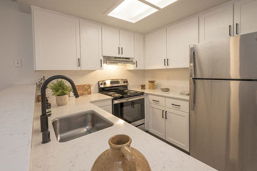 Citrus Heights Apartments - The Arlo - Kitchen with White Cabinets, Quartz Countertops, and Stainless Steel Appliances - Photo Gallery