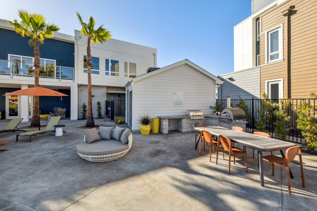 a patio with a table and chairs and a couch in front of a house at 38° NORTH, Santa Rosa, 95404