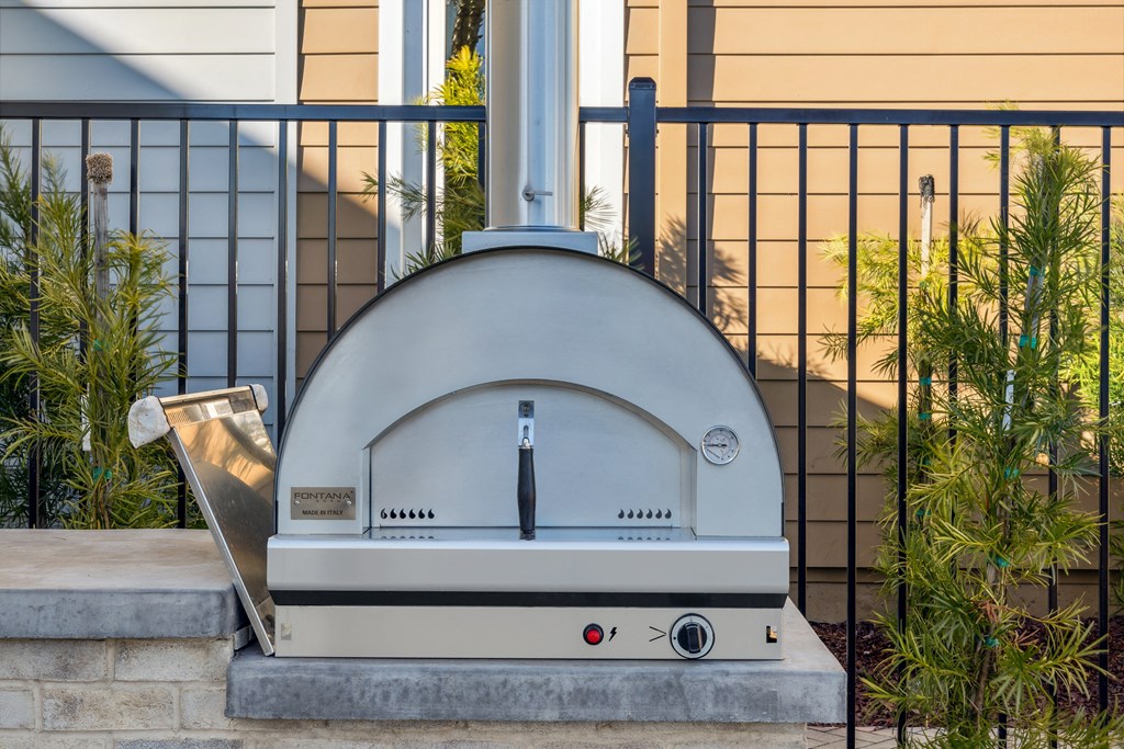 a silver domed oven sitting on a curb in front of a house at 38° NORTH, California, 95404