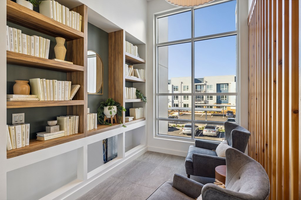 a living room with bookshelves and a large window at 38° NORTH, Santa Rosa