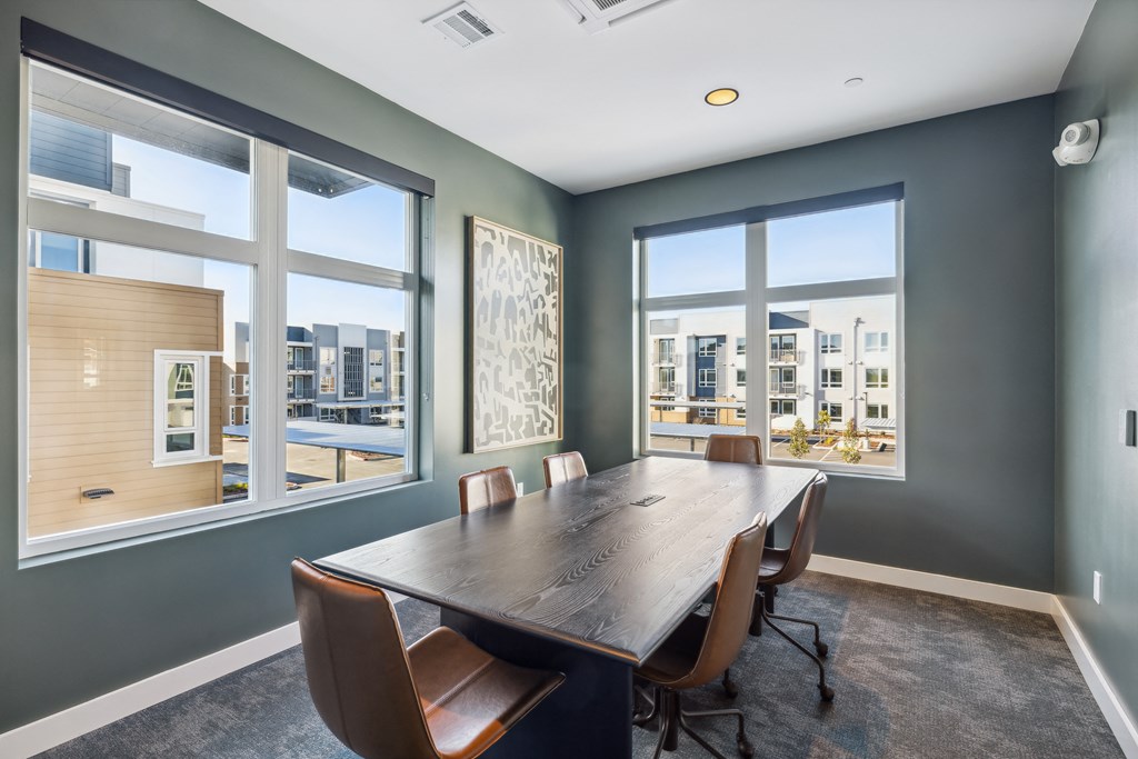 a conference room with a large window and a wooden table and chairs at 38° NORTH, Santa Rosa