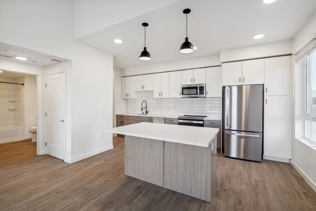 a renovated kitchen with white cabinets and stainless steel appliances at 38° NORTH, California, 95404