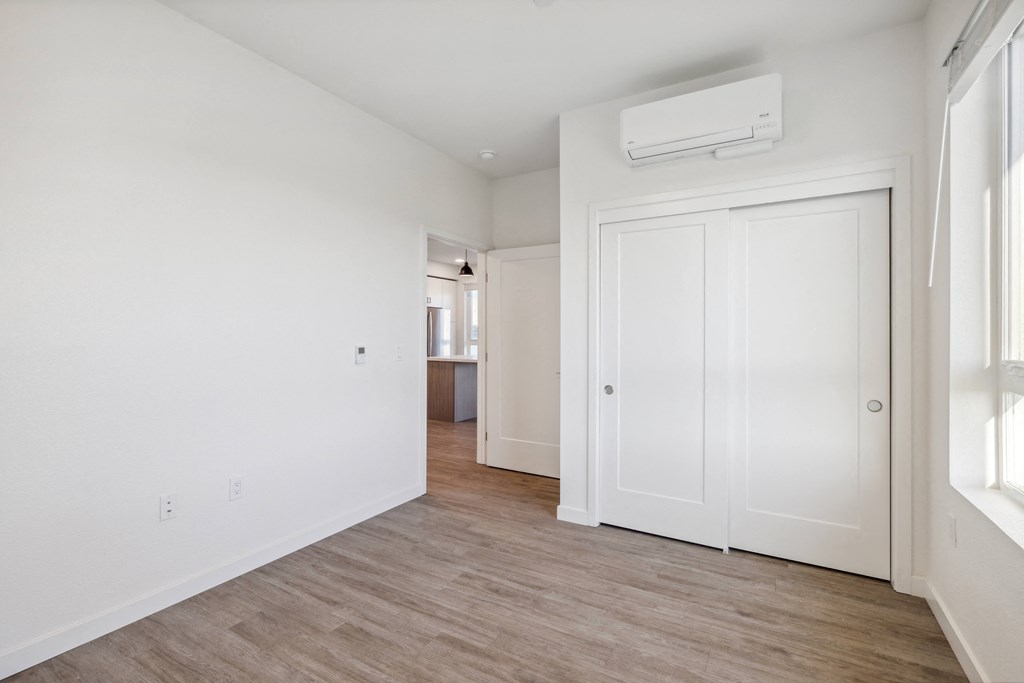 an empty living room with white walls and wood flooring at 38° NORTH, Santa Rosa