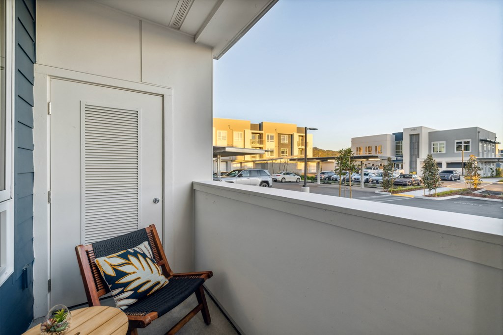 a balcony with a chair and a window overlooking a street at 38° NORTH, Santa Rosa California